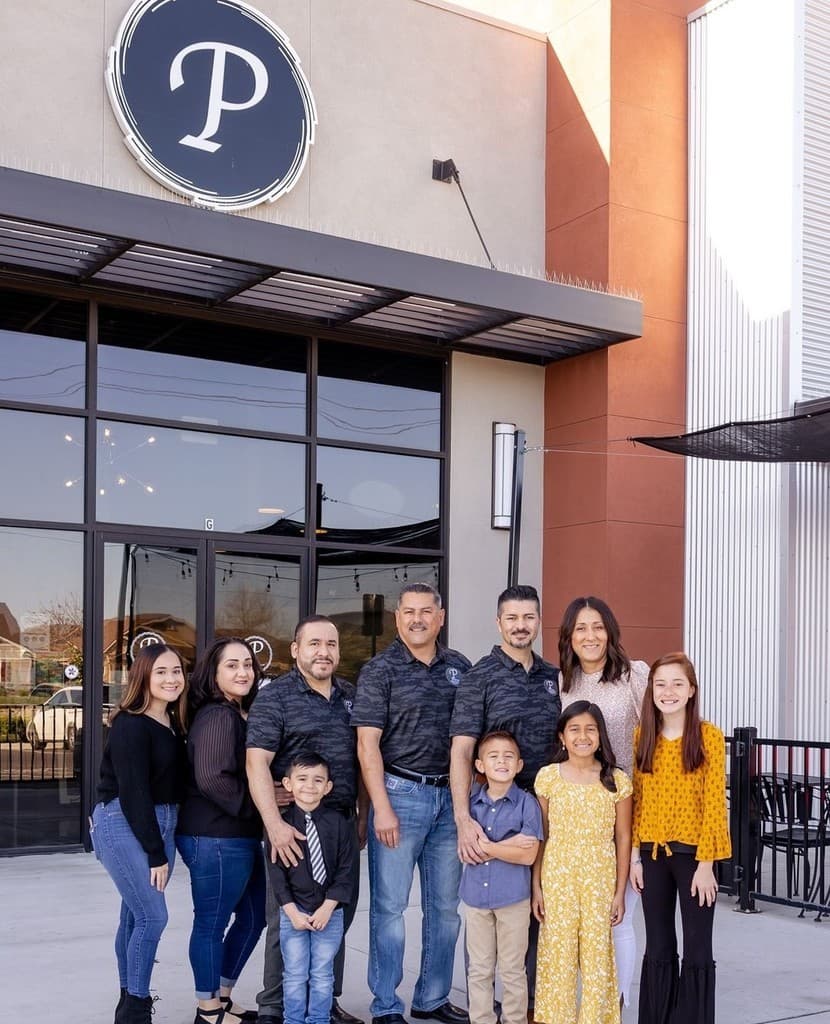 Primos Restaurant owners and family in front of the restaurant